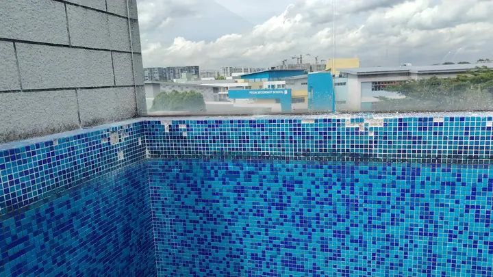 Completed blue mosaic pool wall repair